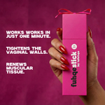 Pink packaging of 'fuhqestick' held by a hand with red nails on a purple background.