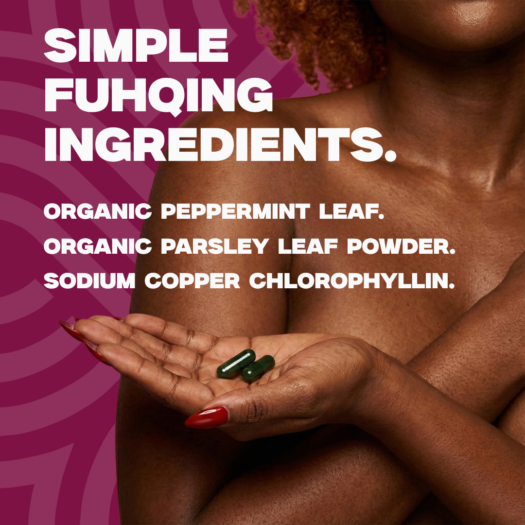 Person holding two green capsules with text about simple ingredients on a pink background