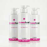 Three bottles of 'showerhead' exfoliating body wash scrub on a white background
