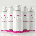 Row of white bottles with pink labels on a light gray background